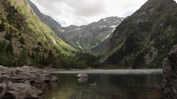 Gimbal dolly shot stepping into the beautiful Lauvitel lake in Venosc, Alps. 4K ProRes