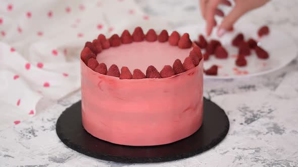 Woman Hands Placing a Raspberries Onto Freshly Cooked Cake