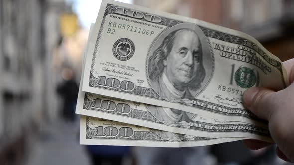 Three Hundred Dollar Bills on Blurred Background of European