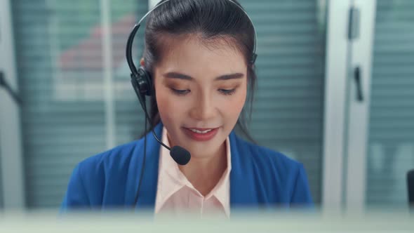 Businesswoman Wearing Headset Working Actively in Office