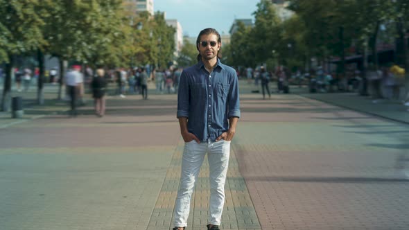 Zoomin Time Lapse of Attractive Middle Eastern Man Standing Outside in Crowded Street with People