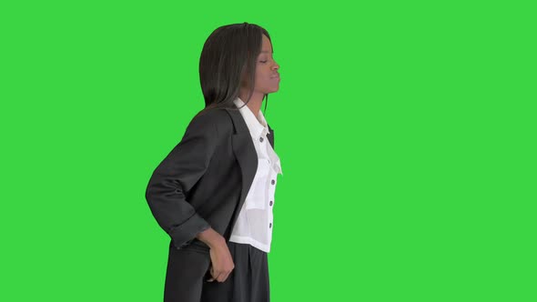 Confident Smiling African American Businesswoman Putting Hands in Her Pockets on a Green Screen