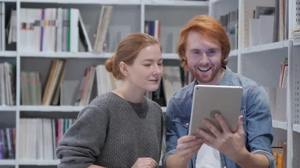Online Video Chat on Tablet By Redhead Man and Woman