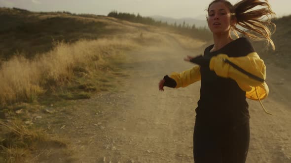 Fit Girl Running Marathon in Mountain Landscape