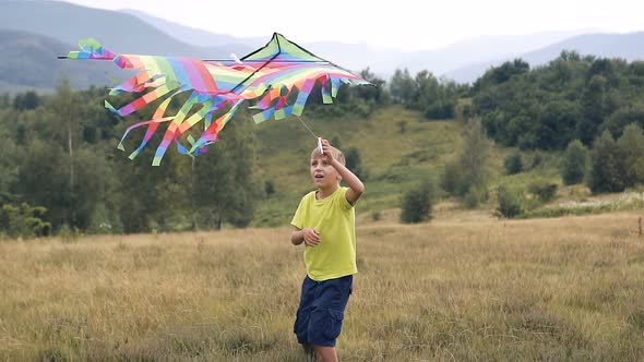 The Boy Runs and Launches a Snake in the Mountains