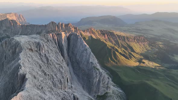 Dolomites mountains peaks with a hiking path on a summer sunrise