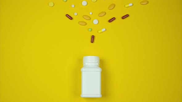 A Variety of Pills Fall Into a White Bottle. Stop Motion Animation