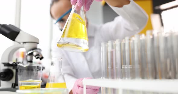 Scientist Conducts Chemical Experiment in Flask with Oil