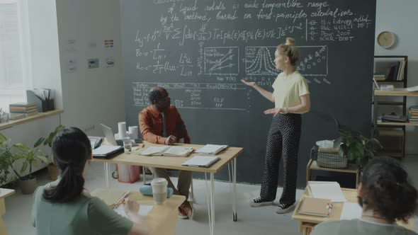 College Girl Giving Presentation to Group on Lesson