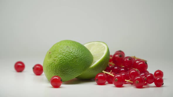 Sweet And Delicious Red Currants With Slices Of Green Limes - Close Up Shot