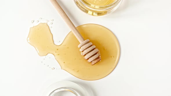 Rotation of the Composition with Fresh Honey on a White Background Top View