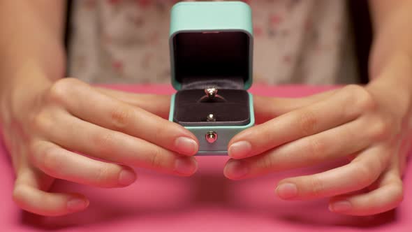 Woman's Hands Holding Ring