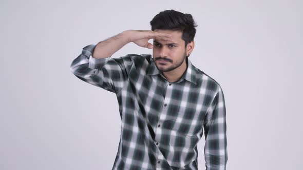 Portrait of Young Handsome Bearded Indian Man Searching Something