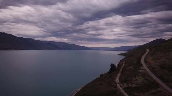 Scenic road by lake Hawea in New Zealand