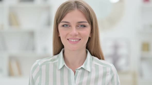 Portrait of Smiling Young Woman Looking at Camera