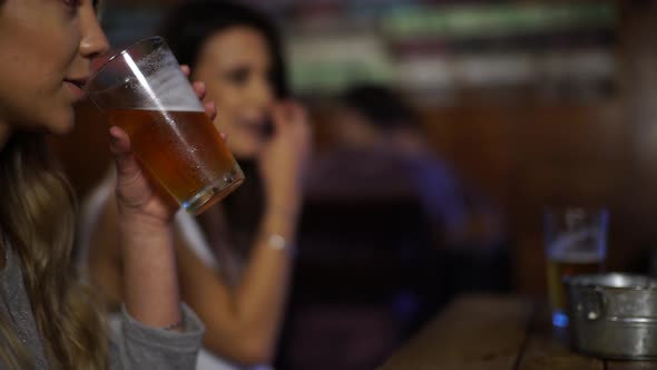 Girl drinking a beer with friends at a bar in Patagonia Argentina