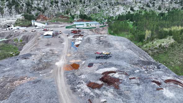 Heavy machinery drills tunnel through the mountain aerial view 4 K