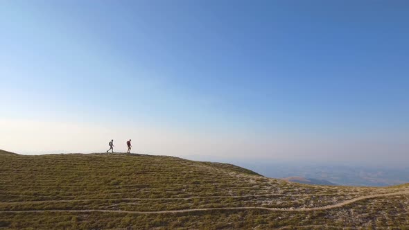 Drone view of two friends hiking in the Apennines, Umbria, Italy