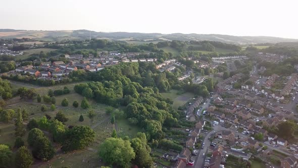 Aerial view of Exeter cemetery surrounded by neighborhood houses at golden hour