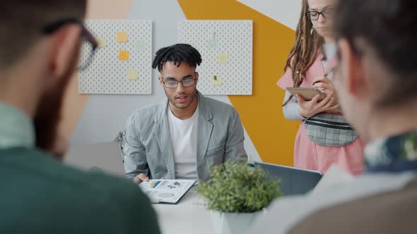 African-American Man Employer Yelling at Group of People During Meeting in Office