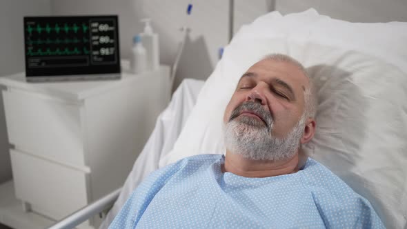 The Face of an Elderly Man Lying on a Bed in a Hospital Unconscious Asleep