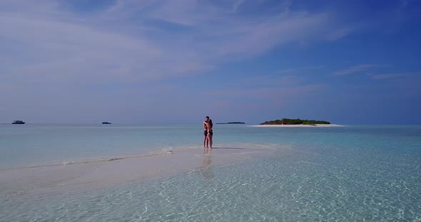 Young lady and man on honeymoon vacation have fun on beach on paradise white sand 4K background