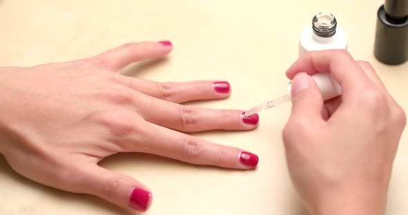 Apply red nail polish on finger nail at home