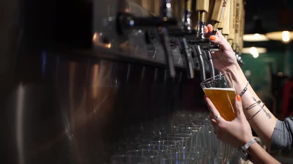 Hands of a girl serving beer in a bar in Patagonia Argentina