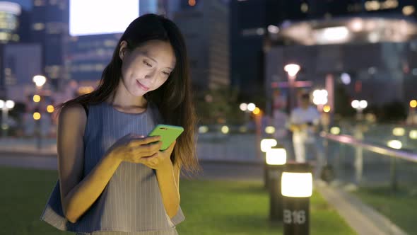 Woman use of mobile phone at night