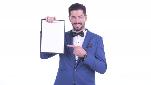 Happy Young Bearded Businessman Showing Clipboard and Giving Thumbs Up
