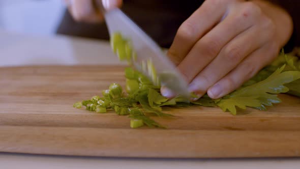 Slicing Of Fresh Celery On Wooden Board