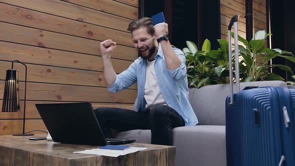 Man on Computer Screen and Waiting for Result and After Raised Happily His Hands Up