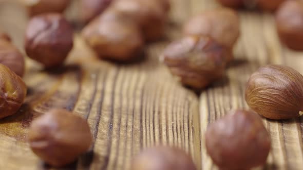 Dried Hazelnuts Lying on a Textured Wooden Table Surface