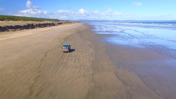 Driving a van on the beach by the sea