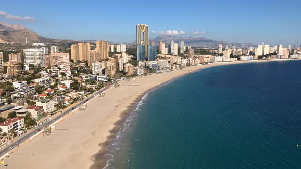 Aerial footage of Benidorm Playa Levante beach, hotels, buildings and restaurants