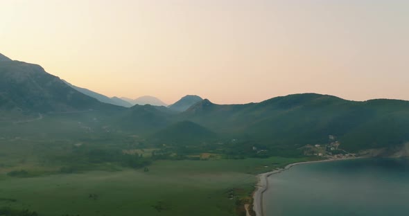 aerial view during sunrise on mountain with clouds and beach