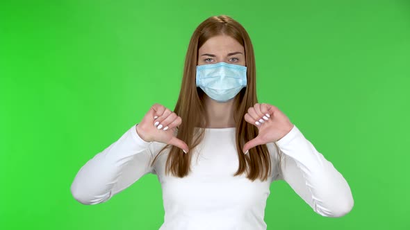 Portrait of Young Girl in Medical Protective Face Mask Looking at Camera and Disgruntled Shakes His