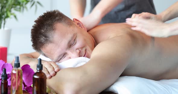 Young Happy Caucasian Man Relaxing During Back Massage