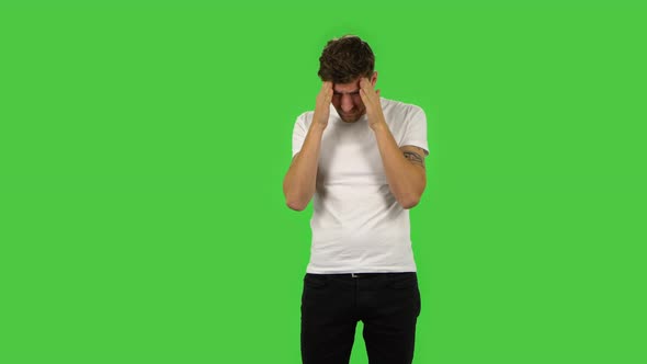 Confident Guy Is Suffering From Headache From Fatigue. Green Screen