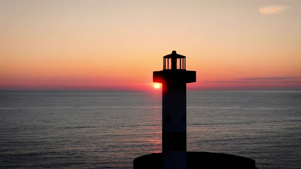 4K drone footage of lighthouse at sunset overlooking the Pacific ocean