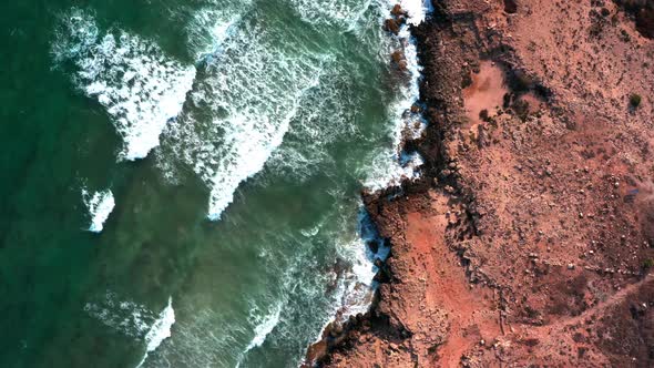 Rough sea waves crashes on the rugged shoreline