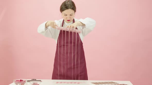 Pretty Female Chocolatier Making Hand-crafted Ruby Chocolate Candies