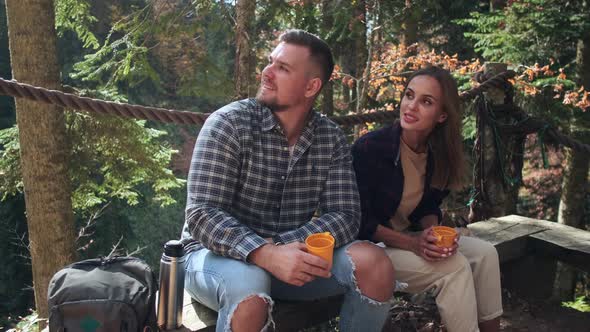 Young Man and Woman are Watching Nature in Park Area