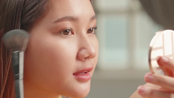 Close Up Asian Girl Makeup With Cosmetic Powder Brush