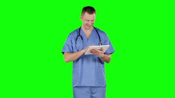 Doctor Uses a Tablet and Shows Thumb. Green Screen