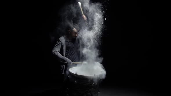 Portrait of a Drummer in Flour on a Black Background