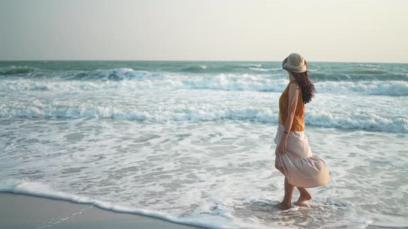 young Asian woman having relaxed and freedom time, walking enjoy on the tropical sea beach