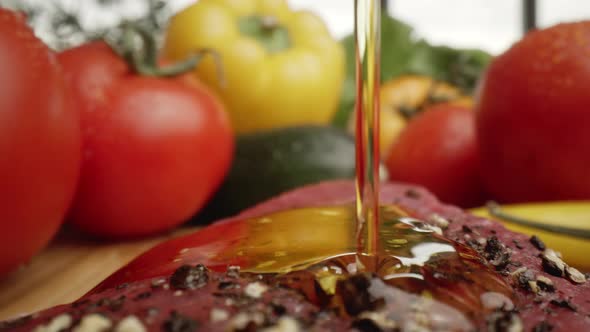 Zoom out macro video of olive oil on raw steak. Shot with RED helium camera in 8K