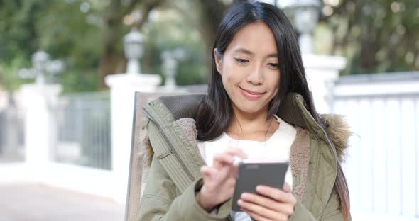 Woman use of smart phone in the city coffee shop