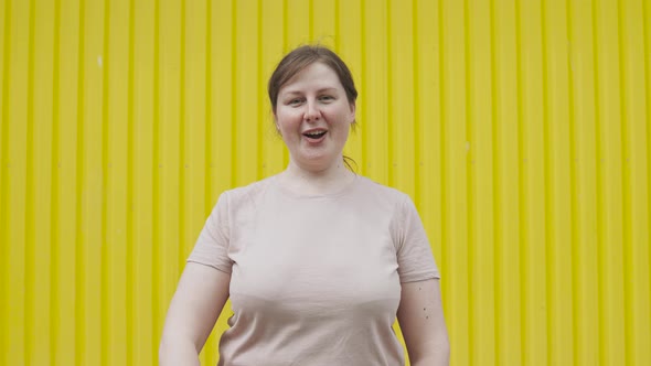 Simple Positive Overweight Paleskinned Woman Showing Ok Sign to the Camera